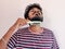 Young Indian man comb his beard and moustache