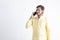 Young indian man in tradition wear and talking on smartphone