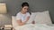 Young Indian Woman doing Paper Work in Bed