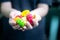 Young indian woman holding colorful fried food made of potato starch and sago called far far fryums which is a popular