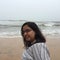 Young Indian woman smiling at the Kunoor beach.