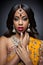 Young Indian woman in traditional clothing with bridal makeup and jewelry