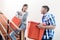 Young indonesian couple in stairway carrying removal crate