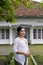 A young Indonesian woman with a happy successful expression wearing a white kebaya. Kartini\'s Day Concept