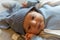 Young infant smiles and plays on his playmat