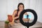 Young influencer woman creating social media videos with smartphone camera while putting on make up - New digital jobs trends,