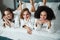 Young inspired ladies in white bathrobes chilling on bed