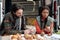 Young intercultural couple of mushroom pickers cutting porcini