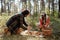 Young intercultural husband and wife checking picked mushrooms