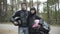 Young interracial couple of bikers standing with helmets outdoors and smiling at camera. Portrait of confident beautiful