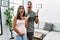 Young interracial couple expecting a baby, touching pregnant belly crazy and mad shouting and yelling with aggressive expression