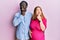 Young interracial couple expecting a baby, touching pregnant belly thinking worried about a question, concerned and nervous with
