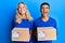 Young interracial couple holding delivery package smiling and laughing hard out loud because funny crazy joke