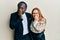 Young interracial couple wearing business and elegant clothes laughing and embarrassed giggle covering mouth with hands, gossip