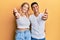 Young interracial couple wearing casual white tshirt smiling friendly offering handshake as greeting and welcoming