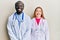 Young interracial couple wearing doctor uniform and stethoscope with a happy and cool smile on face