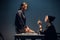 A young investigator an asian woman sits on a table during the interrogation of a pretty criminal