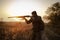 Young irish looking man with a reed, backpack and ammunition belt,  hunting at the countryside