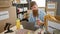 Young irish redhead guy volunteering at community charity center, checking food donations on laptop, working tirelessly indoors