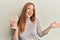 Young irish woman eating healthy rice crackers celebrating achievement with happy smile and winner expression with raised hand