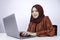 Young Islam woman is serious look with thinking gesture hand on face on the front of Laptop