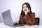 Young Islam woman is serious look with thinking gesture hand on face on the front of Laptop