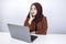 Young Islam woman is serious look with thinking gesture hand on face on the front of Laptop