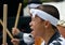 Young Japanese male performing taiko