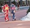 Young Japanese women dressed in Kimonos walking on street with snow on sidewalk