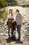 Young jockey kid riding pony outdoors happy with father role as horse instructor in cowboy look