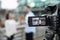 Young journalist interviewing man on street, focus on camera display. Space for text