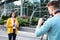 Young journalist and video operator working on street