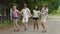 Young joyful friends dancing and having fun in park, summer holidays, youth