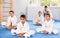 Young karate students perform butterfly