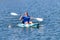 Young Kayaker Paddling Kayak. Sportsman kayaking Blue Water