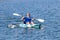 Young Kayaker Paddling Kayak. Sportsman kayaking Blue Water