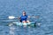 Young Kayaker Paddling Kayak. Sportsman kayaking Blue Water