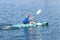 Young Kayaker Paddling Kayak. Sportsman kayaking Blue Water