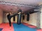 Young kickboxer kicking punching bag in sport gym