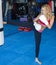 Young kickboxer woman kick into heavy bag in gym