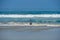 Young kid at the beach enjoying the waves