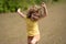 Young kid running and smiling in the park. Active little kid running along street during leisure sport activity. Sporty