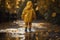 A young kid is walking across a puddle in a yellow raincoat, concept of Adventure, created with Generative AI technology