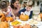 Young kids carving Halloween jack-o`-lanterns