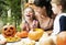 Young kids carving Halloween jack-o`-lanterns