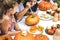 Young kids carving Halloween jack-o`-lanterns