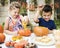 Young kids carving Halloween Jack-o-lanterns