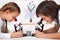 Young kids in science lab study samples under the microscope-focus on the boy face