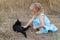 Young kind girl and black cat.