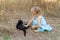 Young kind girl and black cat.